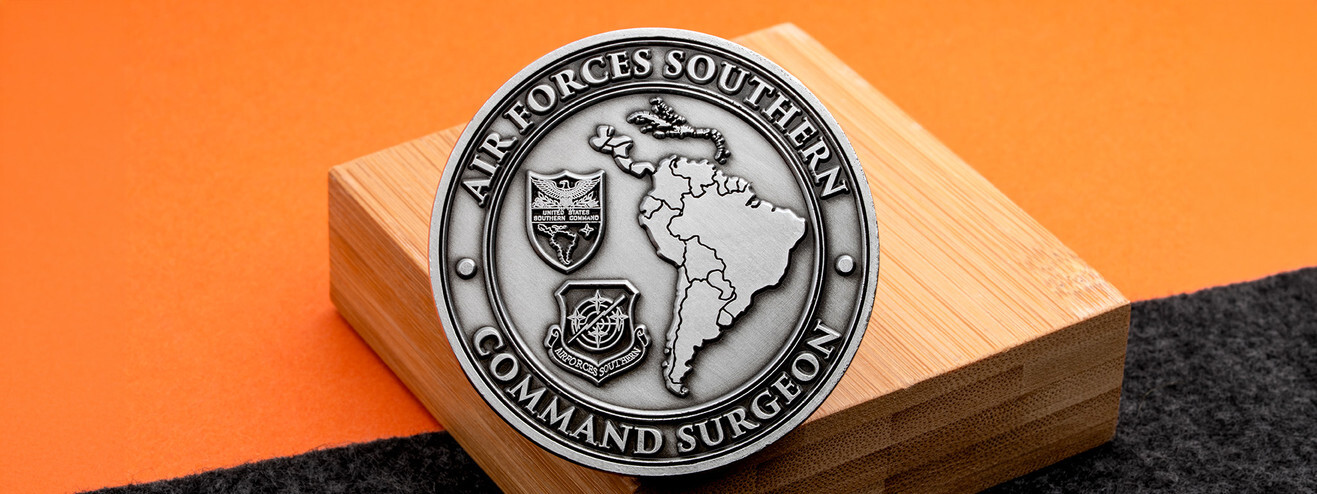 Antique silver Air Forces Southern Command Surgeon coin with a raised map of Central and South America