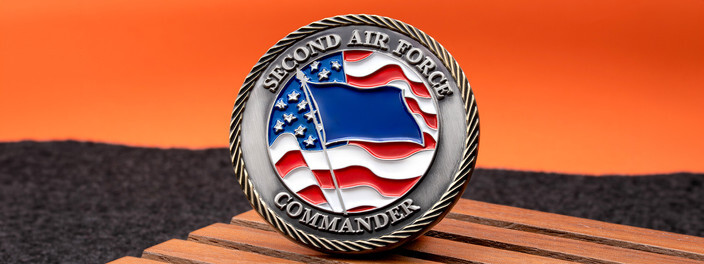 Antique silver Second Air Force Commander coin with a blue flag waving over the U.S. flag