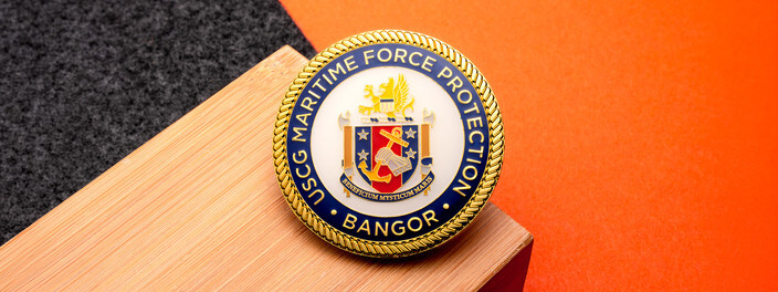 Gold Coast Guard Maritime Force Protection Bangor coin with the unit's crest on a white field inside a navy ring