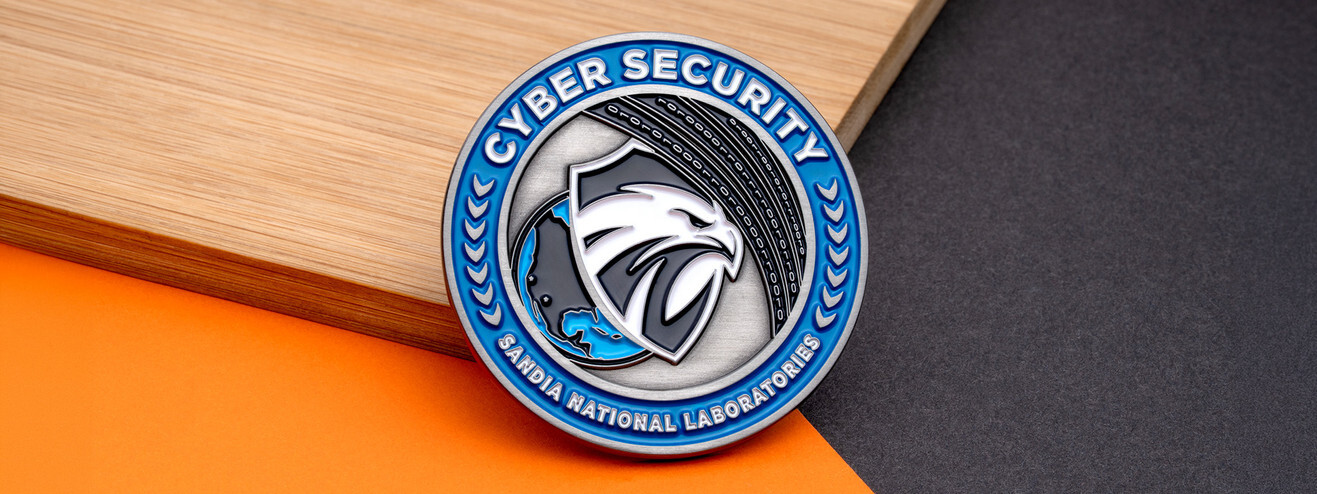 Silver coin with an eagle on a shield over a globe and binary code, ringed in blue by Cyber Security, on bamboo and orange paper