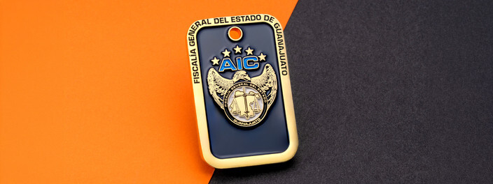 Gold edged navy dog tag with a gold eagle crest under AIC lettering and five stars