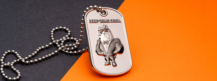 Silver dog tag with a raised cartoon bird in sunglasses and a bow tie under Keep Your Cool, on a ball chain
