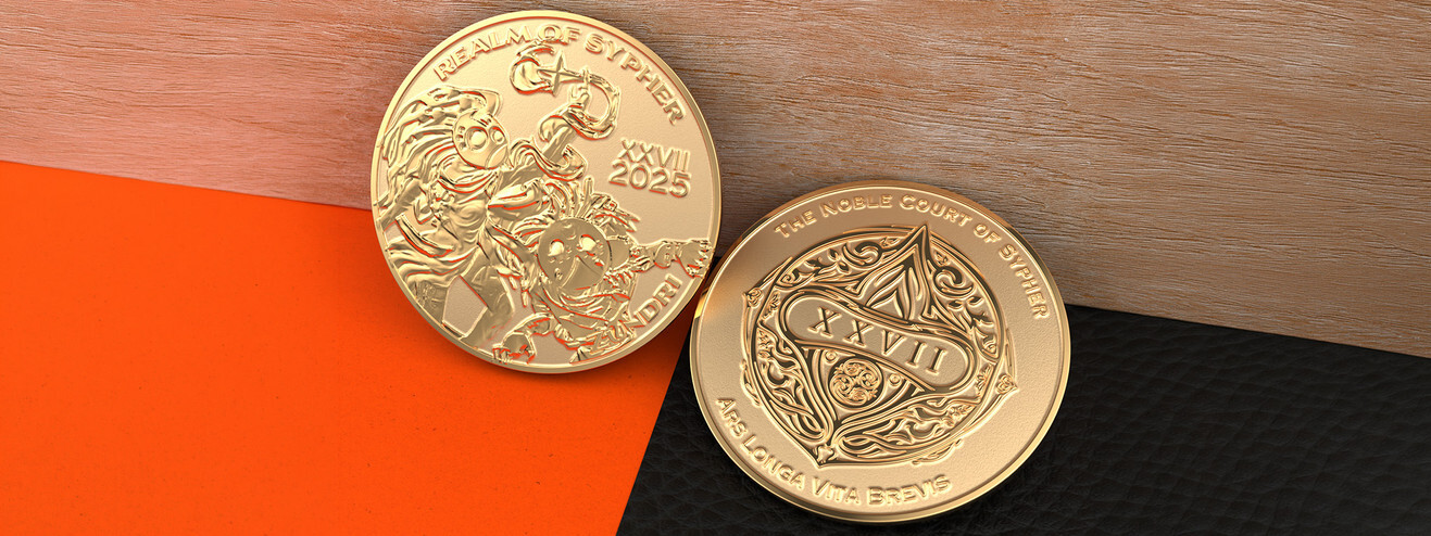 Two gold coins, one with battling fantasy characters and one with an ornate XXVII crest, on wood and orange