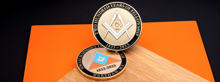 Gold coin with the square and compasses marking two hundred years of fellowship, over a matching lodge coin
