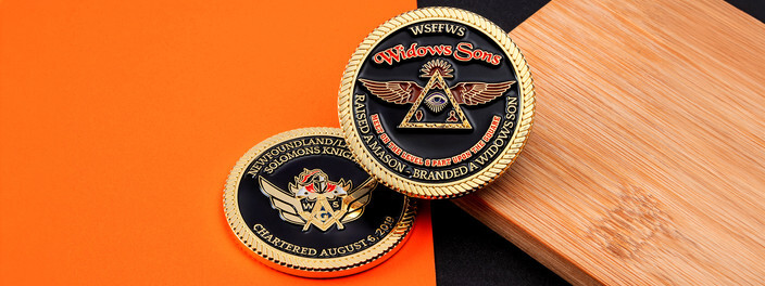 Black and gold coin with a winged triangle and eye, beside a knights coin with crossed swords