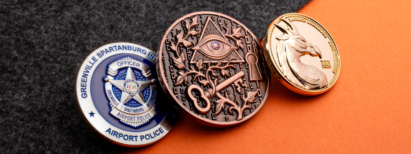 Custom challenge coins for a police department, a fraternal order, and a corporate anniversary