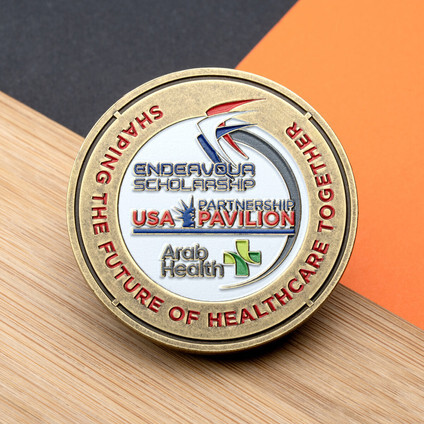 Antique gold coin with full-color enamel healthcare pavilion artwork