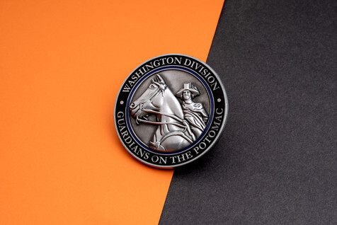 Antique silver coin with a sculpted 3D relief of a horse and rider inside a black ring reading Washington Division, Guardians on the Potomac