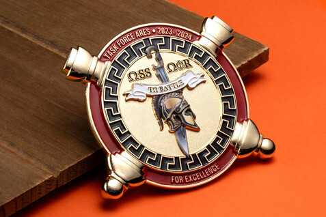 Military unit coin with a helicopter and ship over a Greek key border