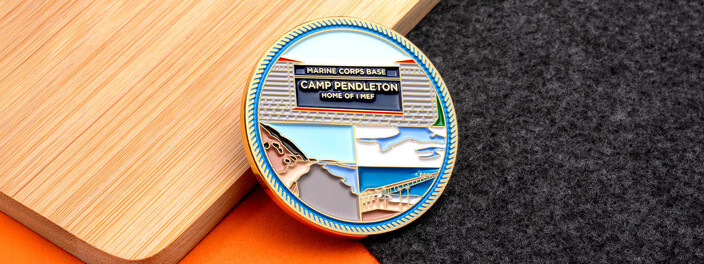 Gold Camp Pendleton base coin with the base sign over a coastline and pier