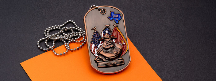 Copper dog tag coin of a bulldog in a drill instructor hat before U.S., Texas and Marine flags, on a ball chain