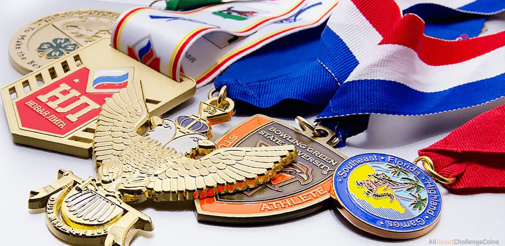 Gold eagle, shield and round enamel medals with red, white and blue neck ribbons on a white surface
