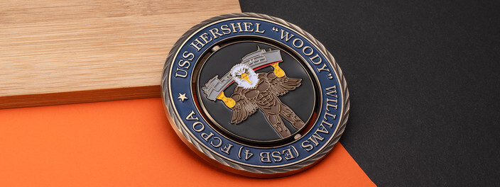 Antique bronze Navy ship spinner coin with an eagle lifting a ship on the center, on bamboo and orange paper