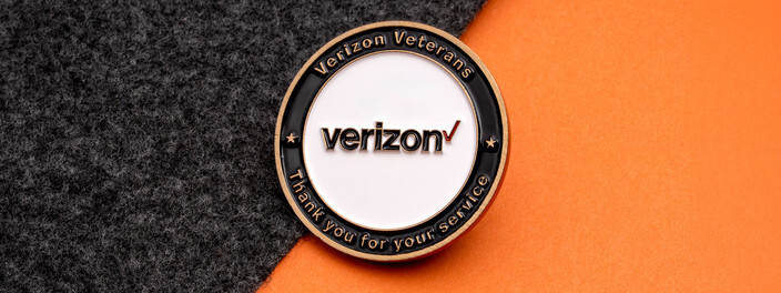 White and black coin with a company logo, ringed by Veterans and Thank You for Your Service