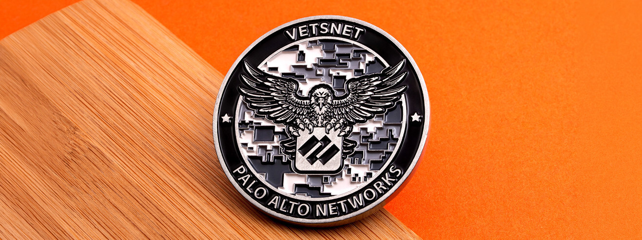 Antique silver coin with an eagle over a digital camouflage field, for a company veterans network, on wood